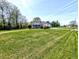 Charming home featuring a well-maintained lawn, mature trees, and an American flag at 3514 Carson Ave, Indianapolis, IN 46227