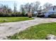 View of the side of a house with a well-maintained driveway and expansive yard at 3514 Carson Ave, Indianapolis, IN 46227