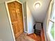 Hallway area featuring a classic wooden door, window, and staircase leading to lower level at 3514 Carson Ave, Indianapolis, IN 46227