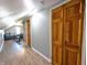 Long hallway with wood floors, doors and access to an attic room at 3514 Carson Ave, Indianapolis, IN 46227