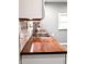 Close-up of a double basin kitchen sink and wooden counter top at 3514 Carson Ave, Indianapolis, IN 46227