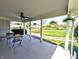 Relaxing covered patio with hanging flower baskets offering a serene outdoor living space at 3514 Carson Ave, Indianapolis, IN 46227