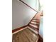 Interior shot of a wooden staircase with white risers, blending classic design with modern flooring at 3514 Carson Ave, Indianapolis, IN 46227