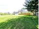 Expansive green lawn and house, with some trees and fencing at 3514 Carson Ave, Indianapolis, IN 46227