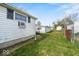 Exterior shot of backyard with siding, grass, and neighboring garages at 3737 Forest Ter, Anderson, IN 46013