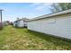 Exterior shot of backyard with siding, grass, and neighboring garages at 3737 Forest Ter, Anderson, IN 46013
