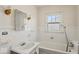 Bright bathroom with tiled walls, a classic sink, and a tub with shower, showcasing a clean aesthetic at 3737 Forest Ter, Anderson, IN 46013