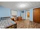Cozy bedroom featuring hardwood floors, natural light, and traditional furnishings, with easy access to hallway at 3737 Forest Ter, Anderson, IN 46013