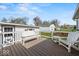 Outdoor deck area with white railings, bench, and chairs, perfect for entertaining at 3737 Forest Ter, Anderson, IN 46013