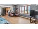 Bright living room featuring hardwood floors, a cozy seating area, and views of the outdoors through large windows at 3737 Forest Ter, Anderson, IN 46013