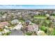 Expansive aerial view of a neighborhood showcasing well-maintained homes and lush landscaping, under a bright blue sky at 3940 Woodcrest Ct, Westfield, IN 46062