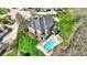 Aerial view of home showcasing the backyard pool, outdoor seating, and lush landscaping at 3940 Woodcrest Ct, Westfield, IN 46062
