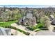 Aerial view of a beautiful brick home with mature trees and professional landscaping in a quiet neighborhood at 3940 Woodcrest Ct, Westfield, IN 46062
