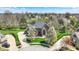 Aerial view of a stunning brick home featuring a large lawn and mature trees in a suburban neighborhood at 3940 Woodcrest Ct, Westfield, IN 46062