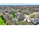 Extensive aerial shot of a neighborhood featuring a well-manicured lawns and lush greenery under a blue sky at 3940 Woodcrest Ct, Westfield, IN 46062