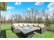 Outdoor view of back deck with outdoor sectional sofa and a gas fire pit at 3940 Woodcrest Ct, Westfield, IN 46062