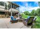 Beautiful backyard showcasing a stone fire pit, comfortable seating, and lush landscaping, perfect for relaxing at 3940 Woodcrest Ct, Westfield, IN 46062