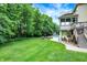 Lush backyard featuring a swimming pool with a slide, a fire pit, and ample green space for recreation at 3940 Woodcrest Ct, Westfield, IN 46062