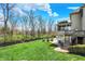 Large backyard with in-ground pool, outdoor seating and dining area, and mature trees in the background at 3940 Woodcrest Ct, Westfield, IN 46062