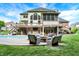 Spacious backyard boasting a pool, a fire pit, covered deck, and mature trees for privacy at 3940 Woodcrest Ct, Westfield, IN 46062