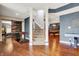 Spacious basement with hardwood floors, game tables, and access to the upper level via a carpeted staircase at 3940 Woodcrest Ct, Westfield, IN 46062