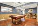 Basement features a pool table with hardwood floors, wainscoting, and a decorative mirror at 3940 Woodcrest Ct, Westfield, IN 46062