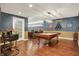 Basement boasts a pool table, hardwood floors, a bar and wainscotting at 3940 Woodcrest Ct, Westfield, IN 46062