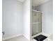 Bathroom showcasing a glass-enclosed shower and neutral-colored tile at 3940 Woodcrest Ct, Westfield, IN 46062