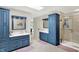 Bright bathroom featuring dual vanities, a walk-in shower, and tile flooring at 3940 Woodcrest Ct, Westfield, IN 46062