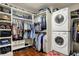 Spacious walk-in closet with custom shelving and a stacked washer and dryer at 3940 Woodcrest Ct, Westfield, IN 46062