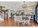 An open floor plan features a dining area with a modern chandelier, an adjacent kitchen, and a staircase at 3940 Woodcrest Ct, Westfield, IN 46062
