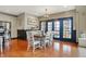 Sunlit dining area with wood floors and modern French doors connects the kitchen to the outdoors at 3940 Woodcrest Ct, Westfield, IN 46062