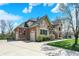 Brick and stone house featuring a three-car garage, well-manicured landscaping, and mature trees at 3940 Woodcrest Ct, Westfield, IN 46062