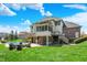 Back of house featuring multiple decks, backyard pool, stone patio, outdoor fire pit, and landscaped yard at 3940 Woodcrest Ct, Westfield, IN 46062
