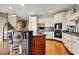 Spacious kitchen with granite countertops, island seating, white cabinets, workstation, and stainless appliances at 3940 Woodcrest Ct, Westfield, IN 46062