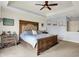 Spacious main bedroom featuring wood-look accent wall, tray ceilings, and a ceiling fan at 3940 Woodcrest Ct, Westfield, IN 46062