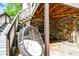 Relaxing outdoor patio area with stone accents, complete with a hanging chair for lounging at 3940 Woodcrest Ct, Westfield, IN 46062