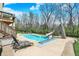 Backyard with large in-ground pool, complete with slide, seating area and surrounding landscaped grounds at 3940 Woodcrest Ct, Westfield, IN 46062