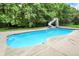 Enjoy this private in-ground pool with a slide and a surrounding patio, perfect for relaxation and summer fun at 3940 Woodcrest Ct, Westfield, IN 46062