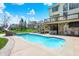 Backyard with in-ground pool, stone patio, hot tub, outdoor seating area, landscaping, and upper deck access at 3940 Woodcrest Ct, Westfield, IN 46062