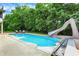 Private in-ground pool offers a great space for summer fun and relaxation with an adjacent patio area at 3940 Woodcrest Ct, Westfield, IN 46062
