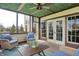 Screened-in porch with cozy seating, ceiling fan, and views of the backyard and abundant natural light at 3940 Woodcrest Ct, Westfield, IN 46062
