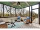 Relaxing screened porch with wicker furniture, blue accents, and a ceiling fan overlooking the yard at 3940 Woodcrest Ct, Westfield, IN 46062