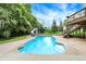 Inviting backyard swimming pool with a slide and surrounding greenery, creating a private oasis at 3940 Woodcrest Ct, Westfield, IN 46062