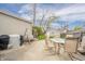 Backyard patio with grill, outdoor dining set, swing, and fenced yard at 4203 Main St, Anderson, IN 46013
