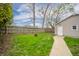 Large fenced backyard with shed and green lawn at 4203 Main St, Anderson, IN 46013