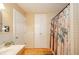Bathroom featuring a tiled shower with a patterned curtain and a built in linen closet at 4203 Main St, Anderson, IN 46013