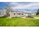 Small home with a green lawn and inviting landscaping, showcasing a tidy exterior at 4203 Main St, Anderson, IN 46013