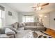 Cozy living room with a large sofa, decorative rug, and a ceiling fan for added comfort at 4203 Main St, Anderson, IN 46013