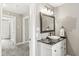 Hall bathroom featuring a vanity with black counter and framed mirror at 4575 N Guilford Ave, Indianapolis, IN 46205